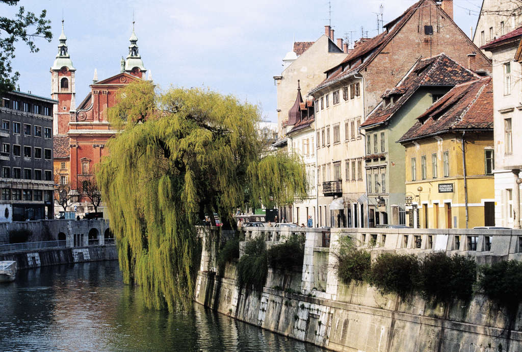 Buildings along the banks of the Ljubljanica River, with the Franciscan Church of the Annunciation in the background, Ljubljana, Slovenia. (Photo by DeAgostini/Getty Images)