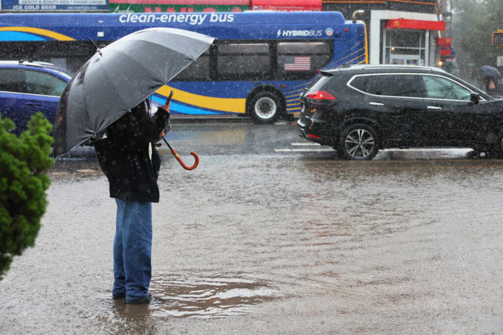 NEW YORK, NEW YORK - SEPTEMBER 29: A person makes a video of a flood water on Parkside Avenue on September 29, 2023 in the Flatbush neighborhood of Brooklyn borough New York City. Flash flooding is expected in the counties of Nassau, Queens and Kings, which includes Brooklyn, according to the state’s National Weather Service office as remnants of Tropical Storm Ophelia reaches the Northeast. Gov. Kathy Hochul has declared a state of emergency for the NYC area. (Photo by Michael M. Santiago/Getty Images)