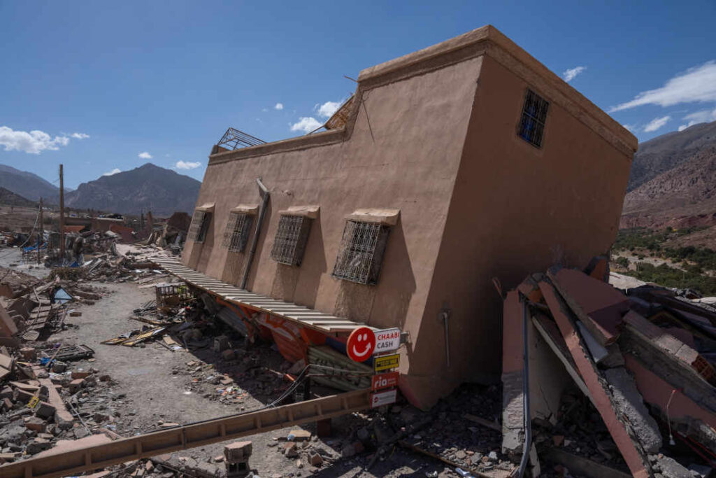 TALAT N'YAAQOUB, MOROCCO - SEPTEMBER 14: A building leans over after partially collapsing, on September 14, 2023 in Talat N'Yaaqoub, Morocco. A huge earthquake measuring 6.8 on the Richter scale hit central Morocco on September 8, with almost 3000 people confirmed dead and many remaining unaccounted for as rescue operations struggle to reach the most affected areas. Whilst the epicentre was in a sparsely populated area of the High Atlas Mountains, its effects have been felt 71km away in Marrakesh, a major tourist destination, where a number of buildings collapsed in the city's medina, a UNESCO World Heritage site. (Photo by Carl Court/Getty Images)